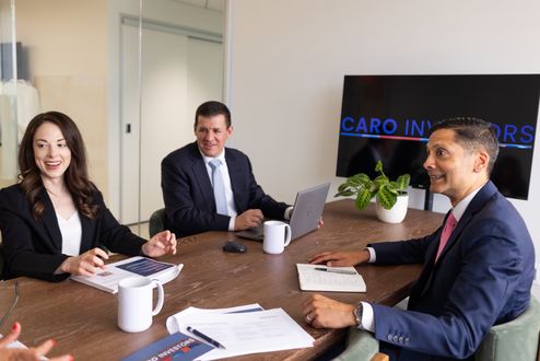 Photo of people at desk in a meeting
